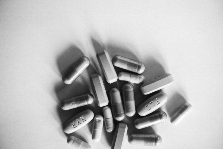 Photo by Anna Tarazevich: https://www.pexels.com/photo/a-grayscale-photo-of-medication-pills-7904443/