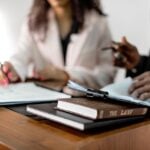 Photo by Mikhail Nilov: https://www.pexels.com/photo/law-book-in-a-podium-8730785/