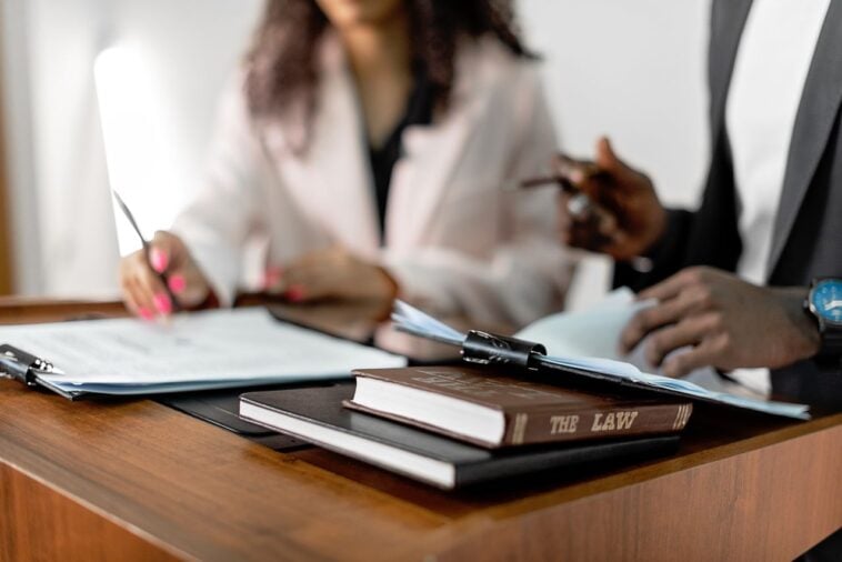 Photo by Mikhail Nilov: https://www.pexels.com/photo/law-book-in-a-podium-8730785/