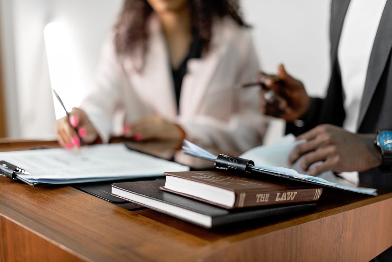 Photo by Mikhail Nilov: https://www.pexels.com/photo/law-book-in-a-podium-8730785/