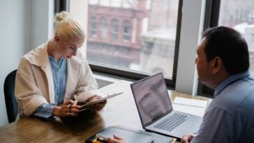 Photo by Sora Shimazaki: https://www.pexels.com/photo/serious-young-woman-reading-report-to-colleague-in-contemporary-workspace-5668853/