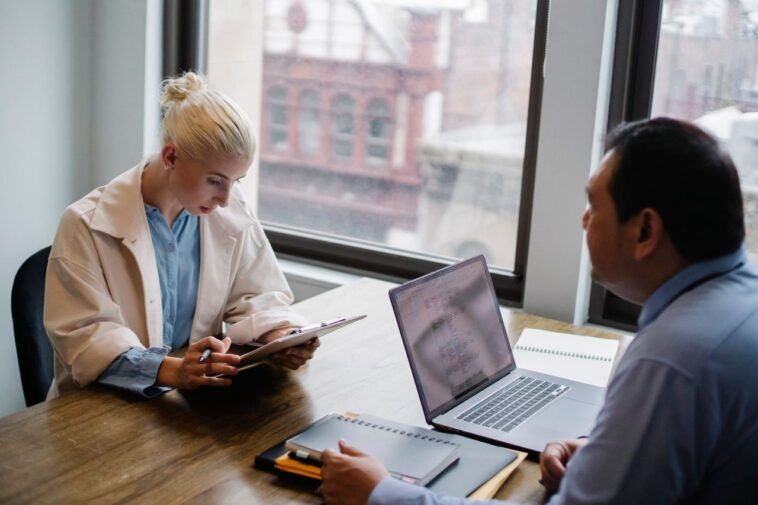 Photo by Sora Shimazaki: https://www.pexels.com/photo/serious-young-woman-reading-report-to-colleague-in-contemporary-workspace-5668853/